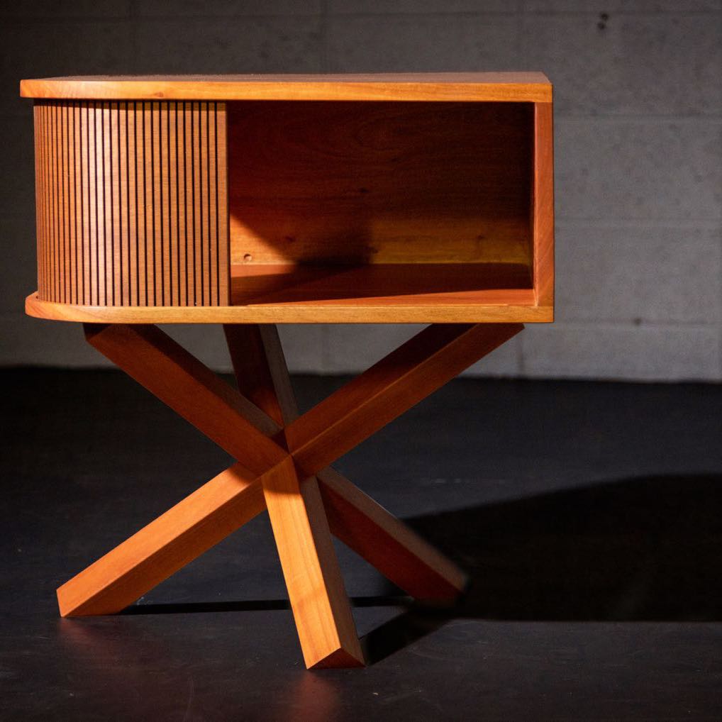 Wood nightstand with a tambour door, an open shelf and crossed wooden legs