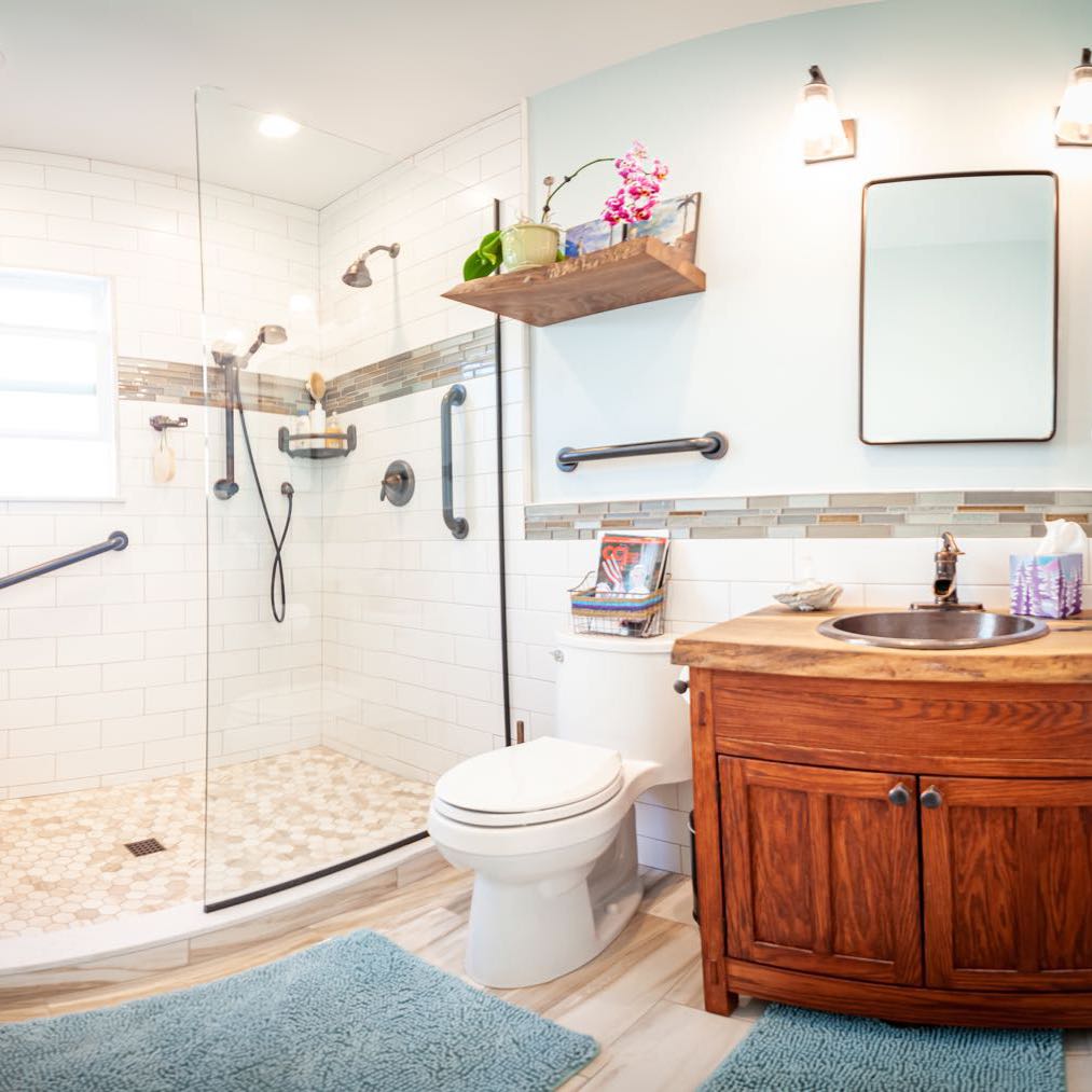 Bathroom vanity with a live edge wood top and a copper sink, under a live edge floating shelf