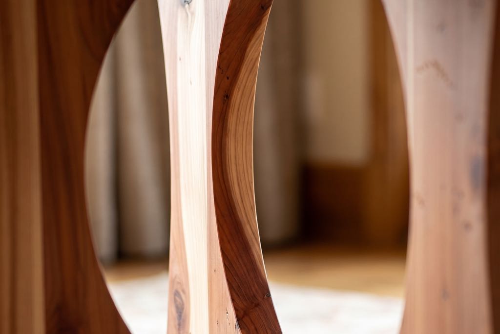Looking through the large circular cutout in one of the redwood base panels