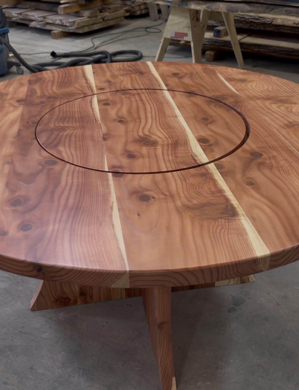 The redwood top seen from above, with the lazy Susan circle and two sapwood stripes