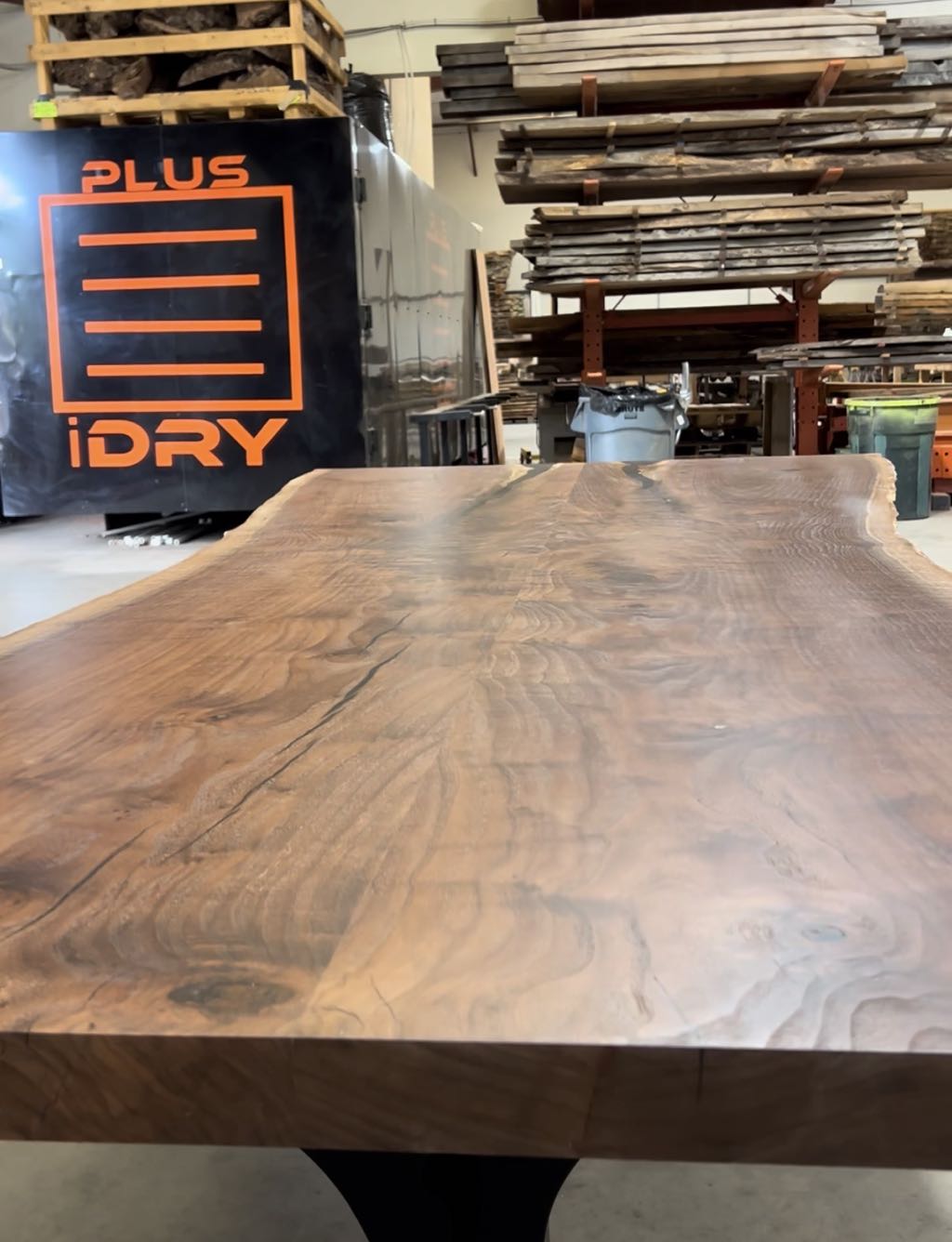 The walnut top from a low angle at one end, with its figure and live edges