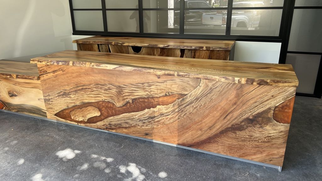 The finished sycamore bar installed at Hope on Park, with its orange resin river, and the credenza standing behind it in front of the tall black-framed windows